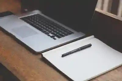 image of laptop and notebook with pen sitting on top